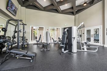 A spacious gym with a variety of equipment including treadmills, weights, and exercise machines.